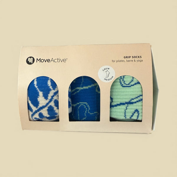 MoveActive grip socks packaging with three pairs of socks inside on a beige background