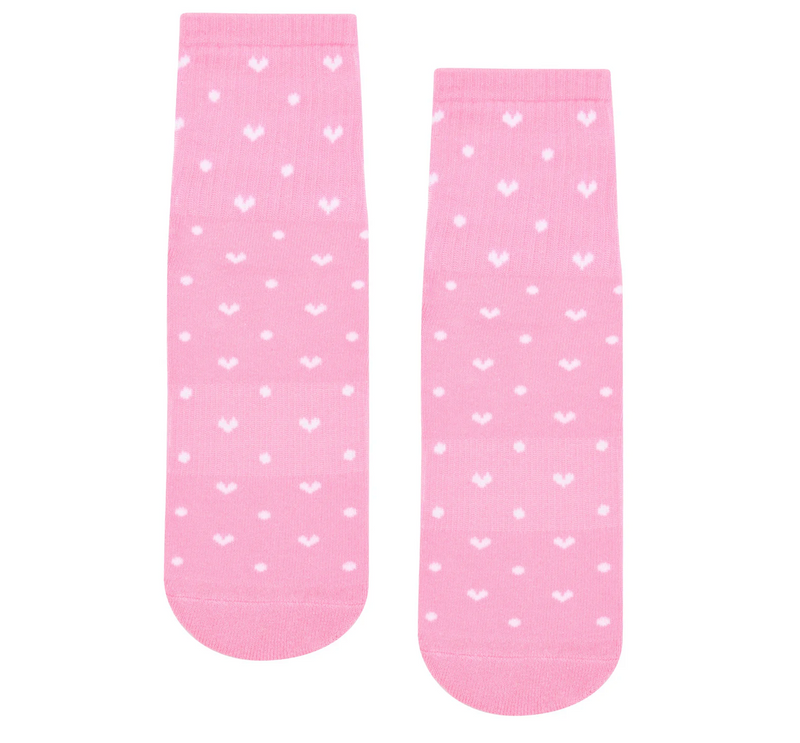 Pair of pink socks with white heart patterns on a white background