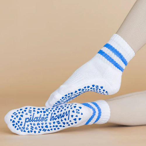 White socks with blue patterns and text on a beige background