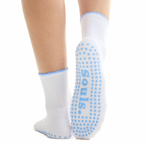 White socks with blue grip dots on a white background