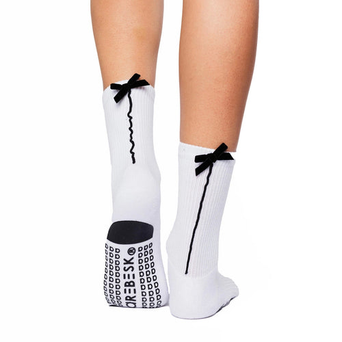 White socks with black bows and text worn by a person on a white background
