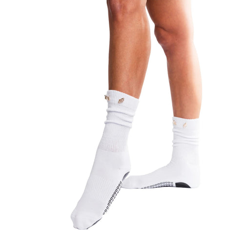 White socks with brand logo worn by a person on a white background