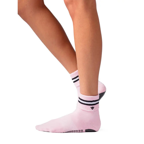 Pink socks with black stripes worn by a person on a white background