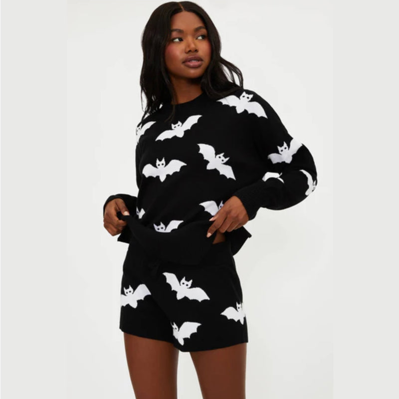 Black outfit with white bat patterns worn by a model on a white background