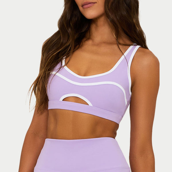 Lavender sports bra and leggings set on a plain background