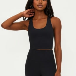 Woman wearing a black athletic outfit on a white background