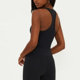 Person wearing a black workout set on a white background