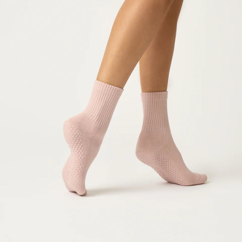 Pink socks worn by a person on a white background