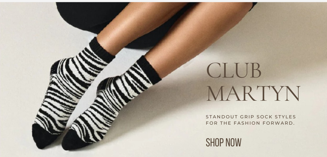 Zebra-striped socks worn by a person with 'Club Martyn' branding and text.