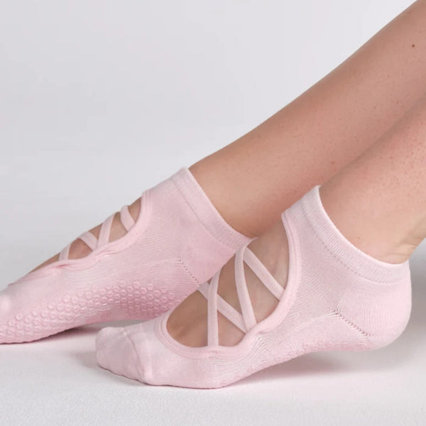 Pink ballet-style socks with cut-out design on a light gray background