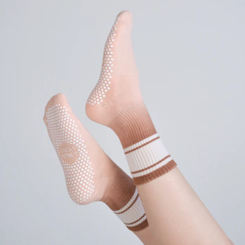 Beige socks with brown stripes on a light gray background