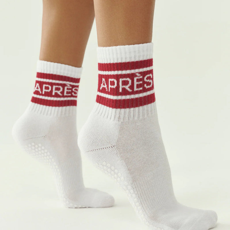 White socks with red accents and 'APRÈS' text on a light background
