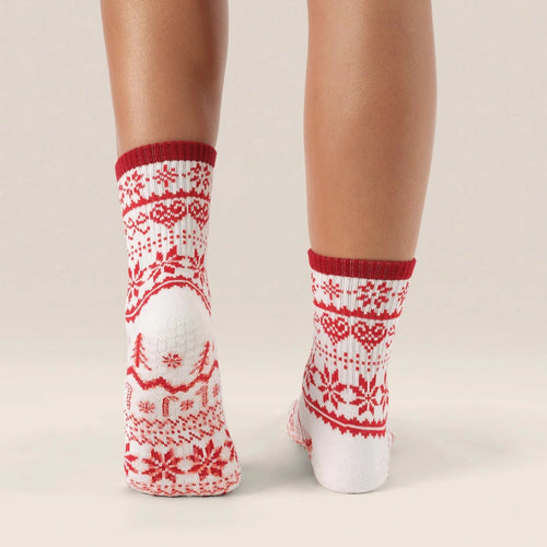 Red and white patterned socks worn by a person on a beige background