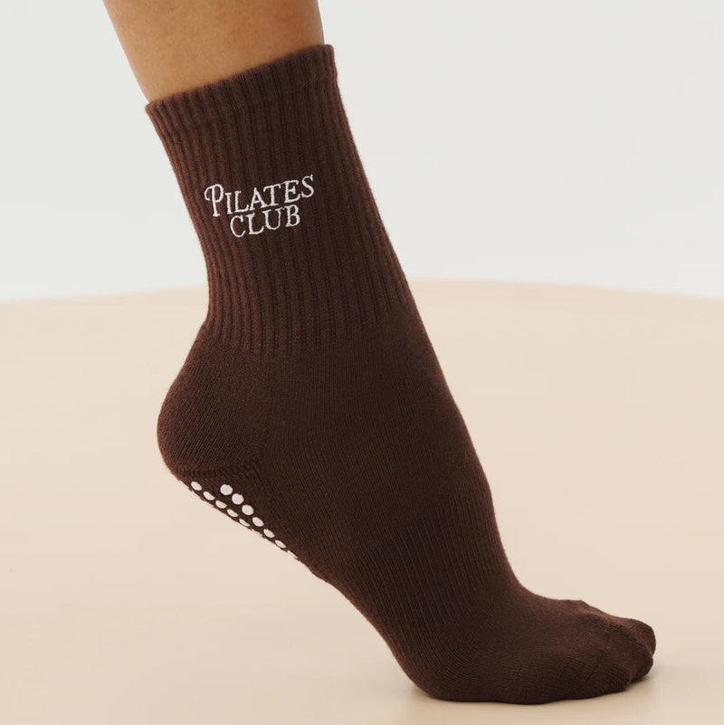 Brown Pilates Club sock on a beige background