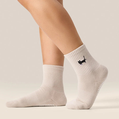 White socks with a small logo on a neutral background