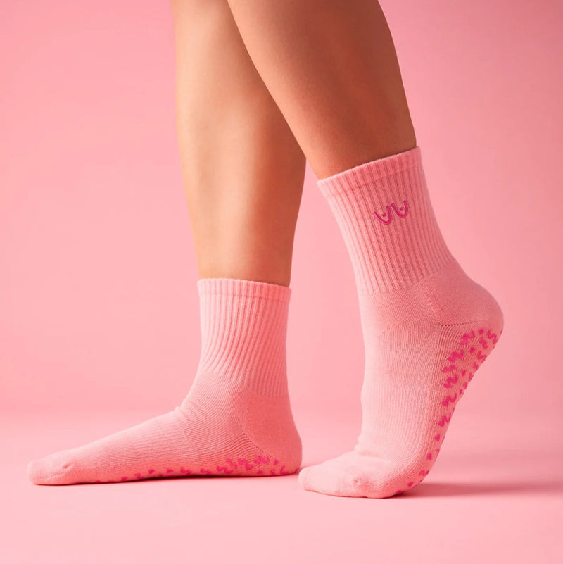 Pink socks with non-slip sole on a pink background