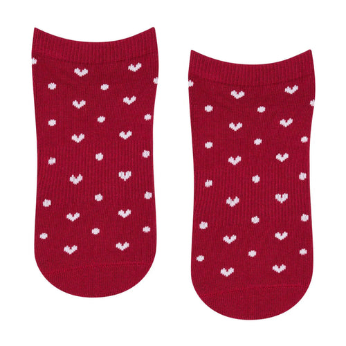 Red socks with white heart patterns on a white background