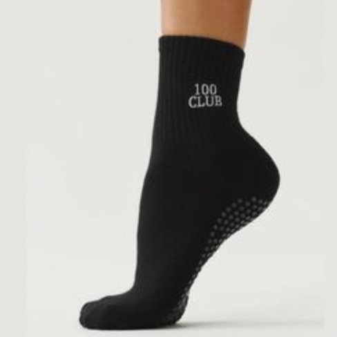Black sock with '100 Club' text on a light gray background