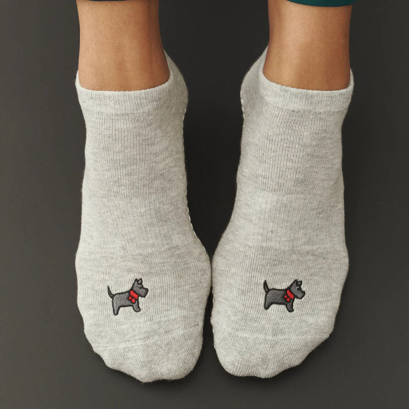 Gray socks with dog embroidery on a dark background