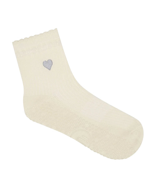 Beige sock with a heart-shaped gray emblem on a white background