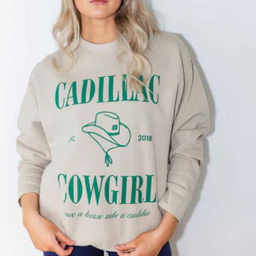 Woman wearing a gray sweatshirt with 'Cadillac Cowgirl' text and graphics on a white background