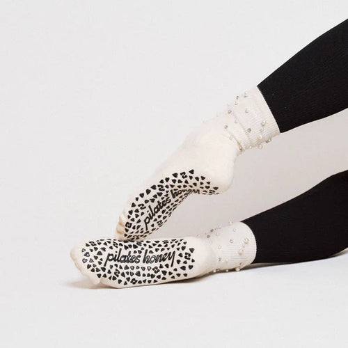 White grip socks with pearls worn by a person on a white background