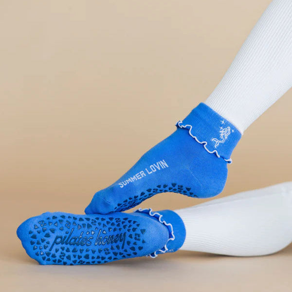 Blue socks with textured sole on a beige background