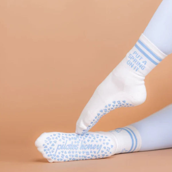 White socks with blue text and patterns on a beige background