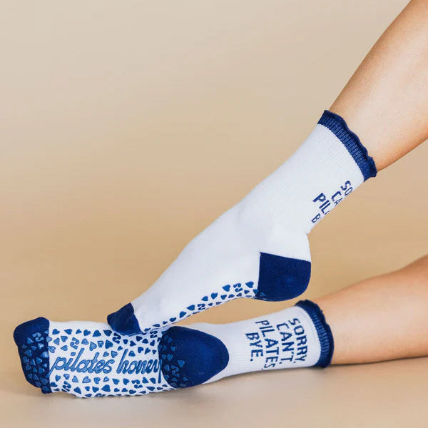 White socks with blue accents worn by a person on a beige background