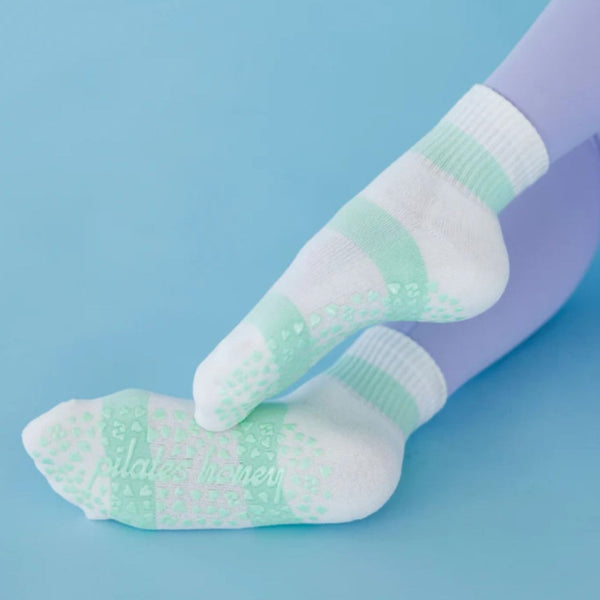 Green and white patterned socks on a blue background