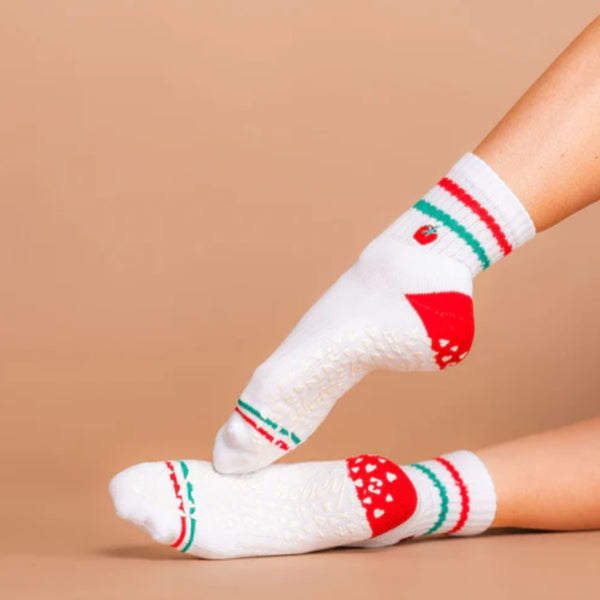 White socks with red and green patterns on a beige background