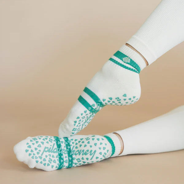 White socks with green patterns and text on a beige background