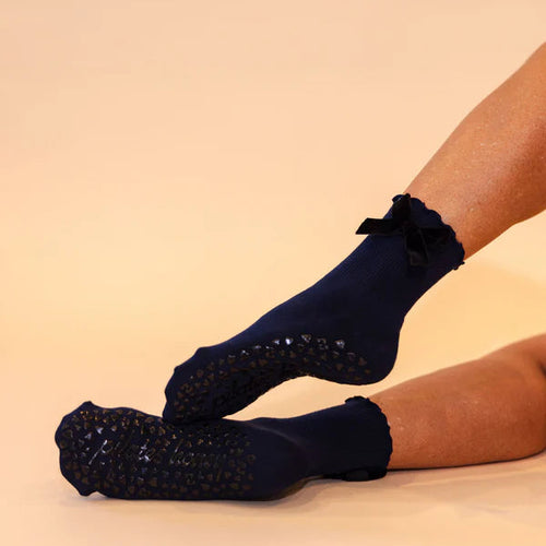 Black socks with decorative elements on a beige background