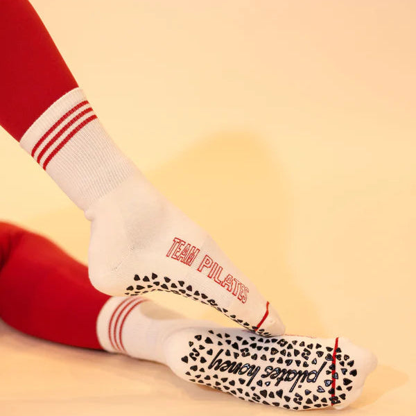 White socks with red text and black pattern on a beige background