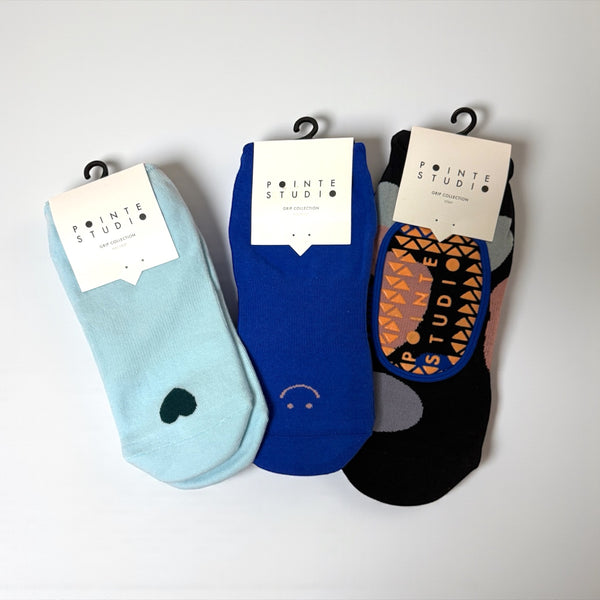 Three pairs of socks with visible branding on a white background