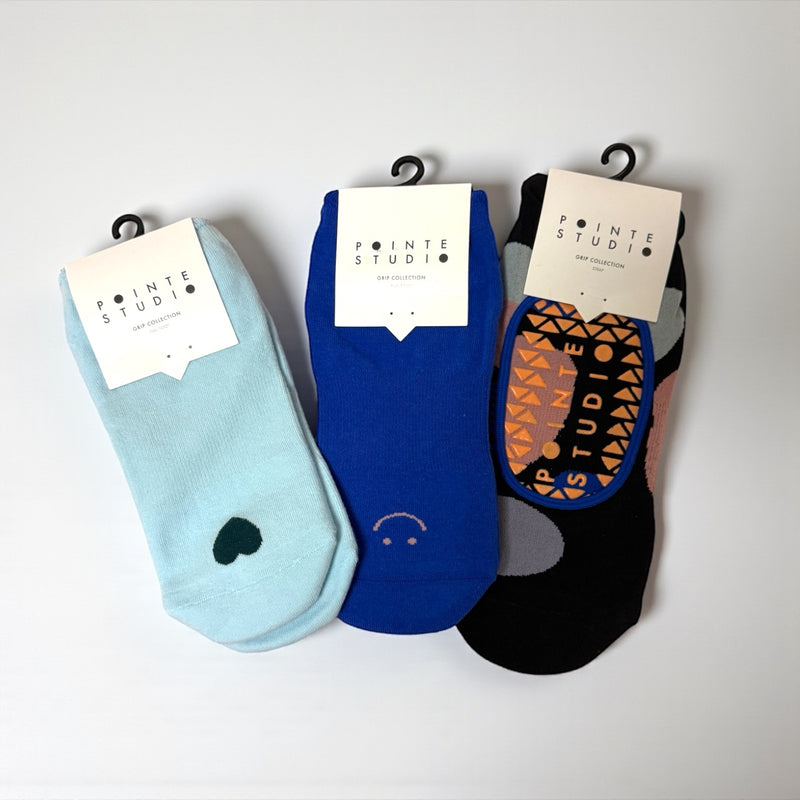 Three pairs of socks with visible branding on a white background