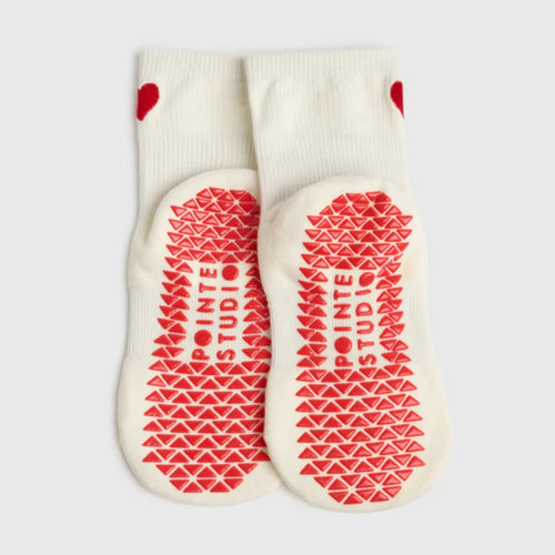 White socks with red pattern and 'Pointe Studio' branding on a light gray background