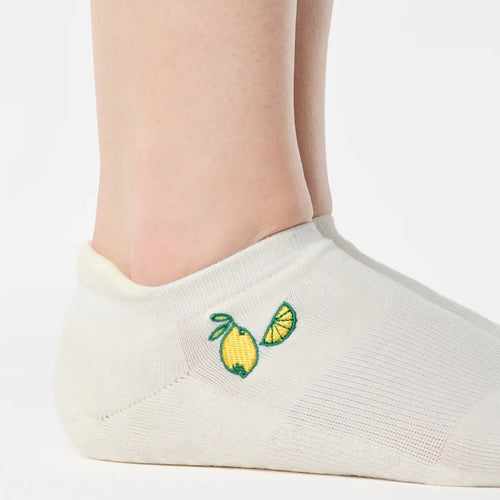 White ankle sock with embroidered lemons on a white background