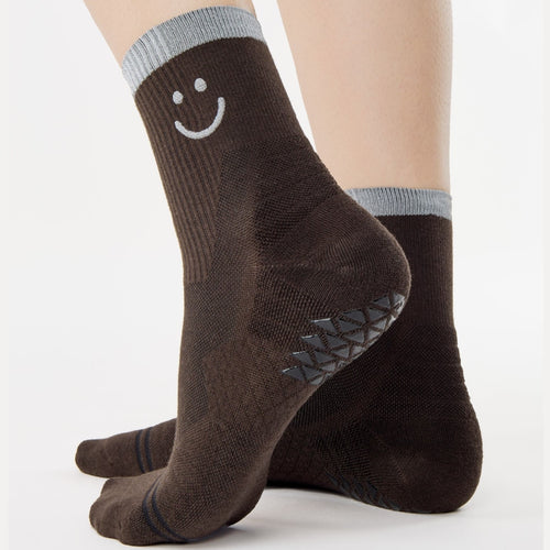 Brown socks with smiley face design on a white background
