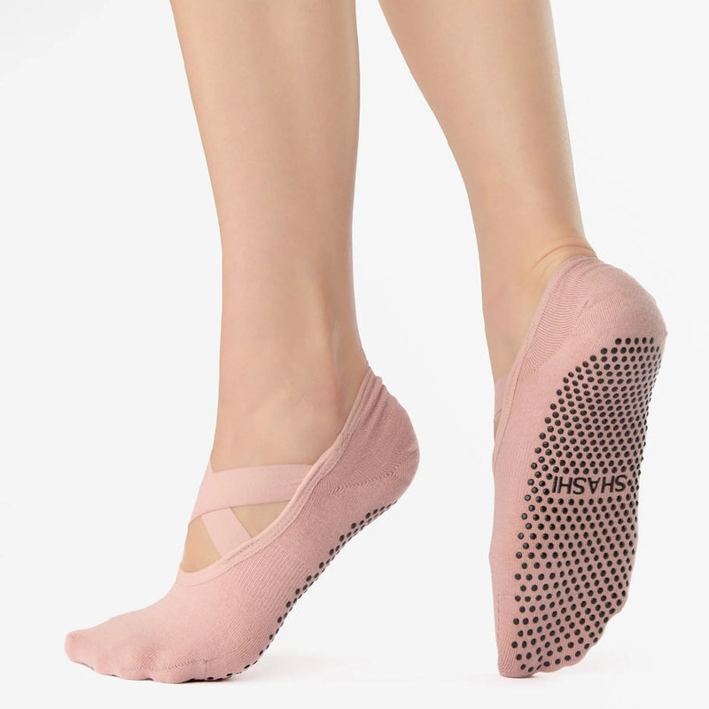 Pink yoga socks with non-slip sole on a white background