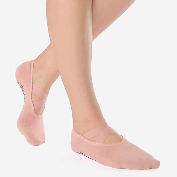 Pink ballet-style socks worn on a white background