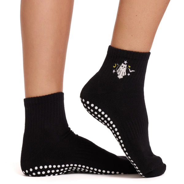 Black socks with white polka dot sole and cat design on a white background