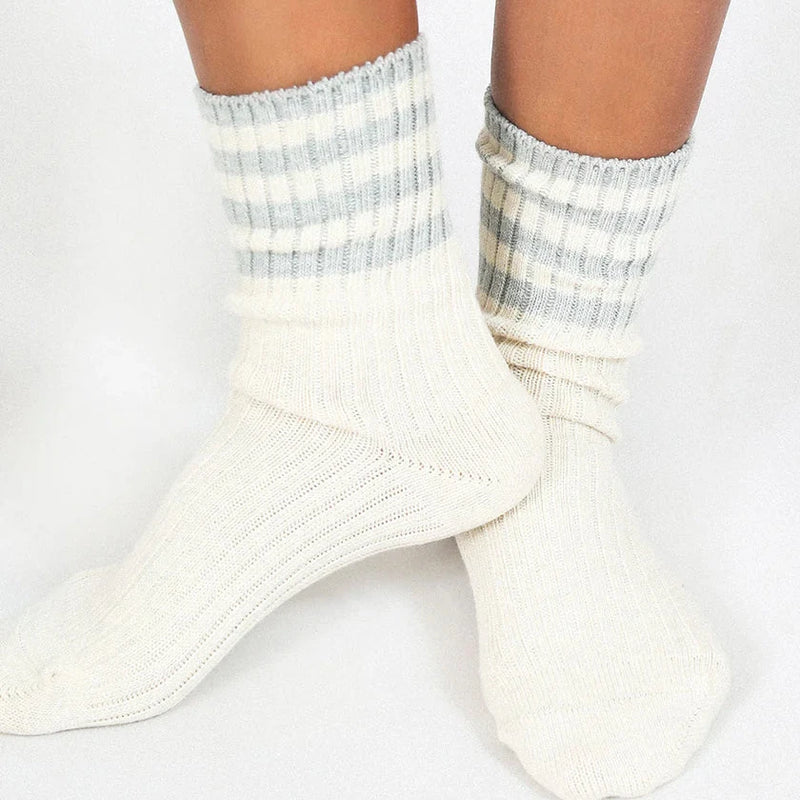 White socks with gray and white striped cuffs on a white background