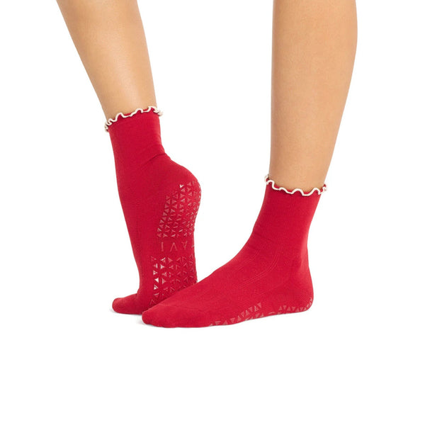 Red socks with white trim worn by a person on a white background