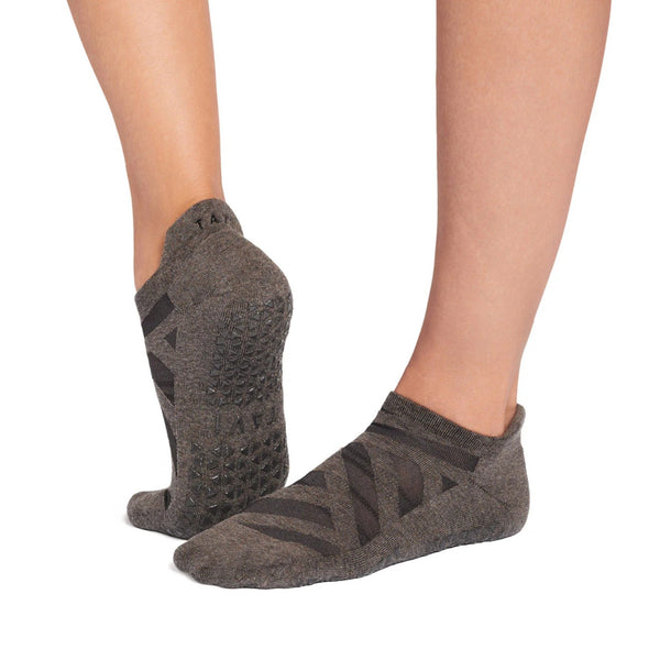 Gray ankle socks with textured sole and brand logo on a white background