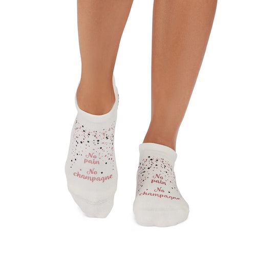 White socks with 'No pain, No champagne' text worn by a person on a white background