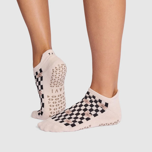 Checkered socks worn by a person on a light gray background