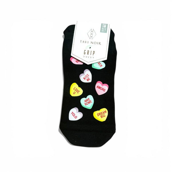 Black sock with colorful heart-shaped text on a white background