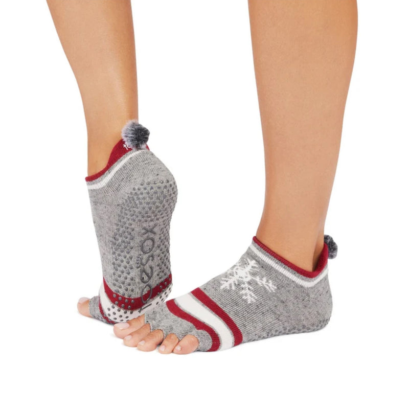 Gray toe-separated socks with red accents worn by a person on a white background