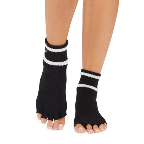 Black toe-separated socks with white stripes worn by a person on a white background